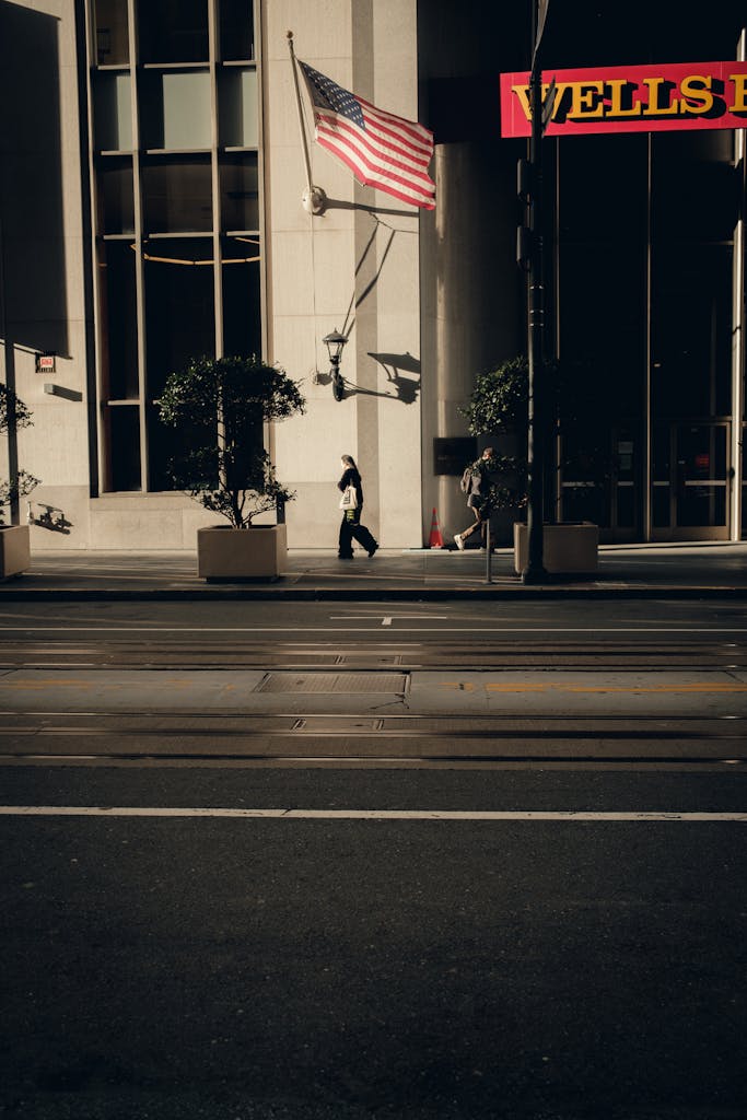 A person walking down the street with a flag