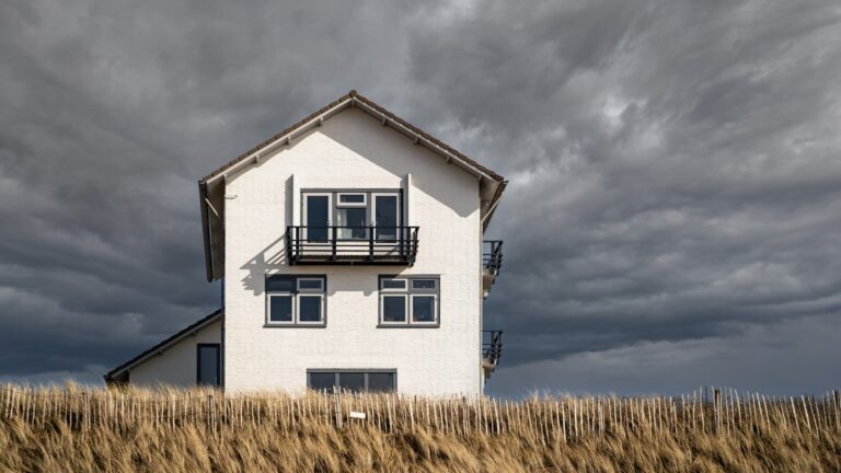white and black house under gray clouds