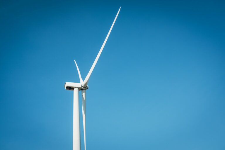 a wind turbine is shown against a blue sky