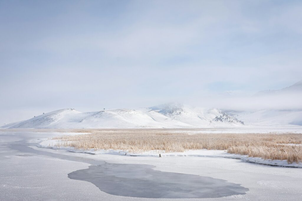 snow covered mountain under white clouds during daytime