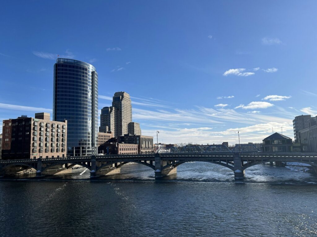 A bridge over a body of water with a city in the background