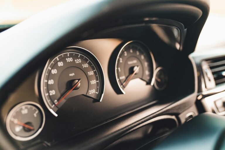 Detailed view of a car dashboard featuring speedometer gauges, ideal for automotive themes.