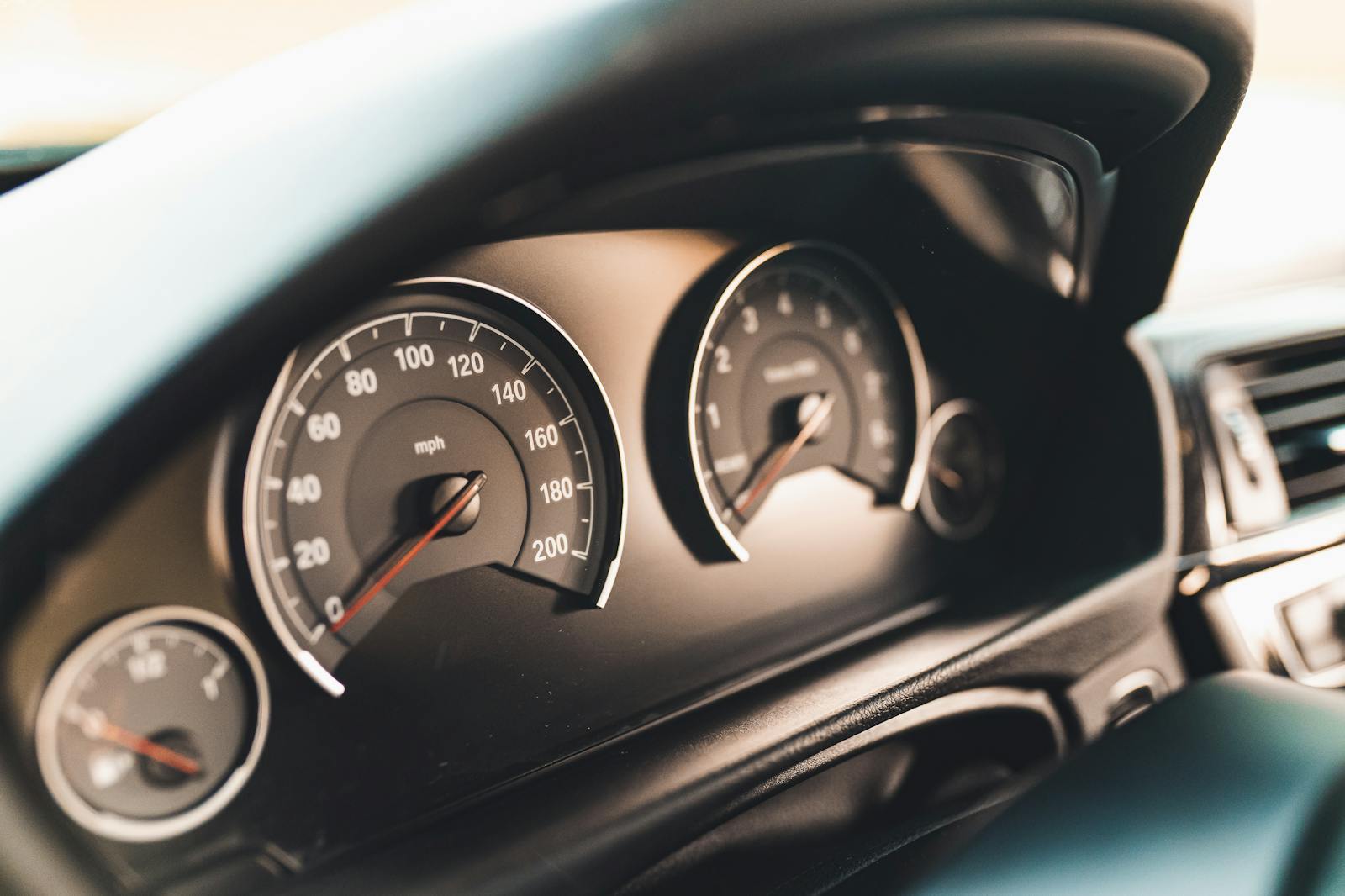 Detailed view of a car dashboard featuring speedometer gauges, ideal for automotive themes.
