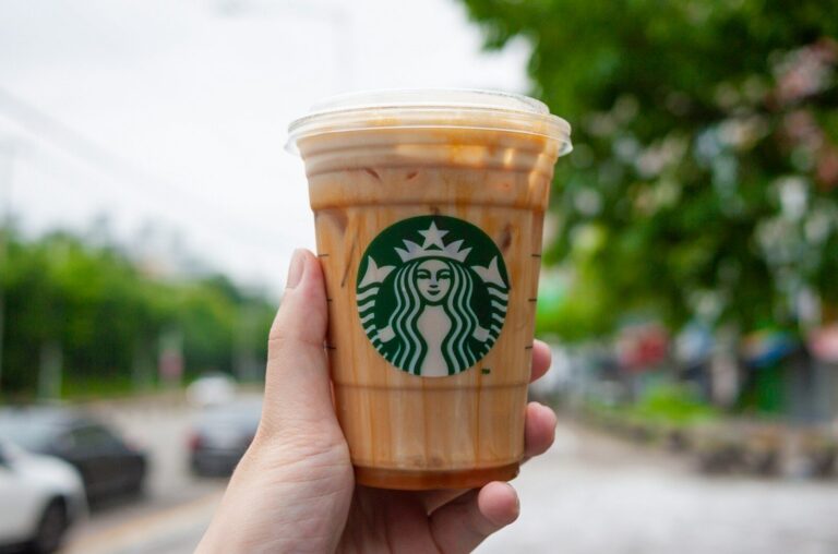 Hand holding a starbucks iced coffee drink