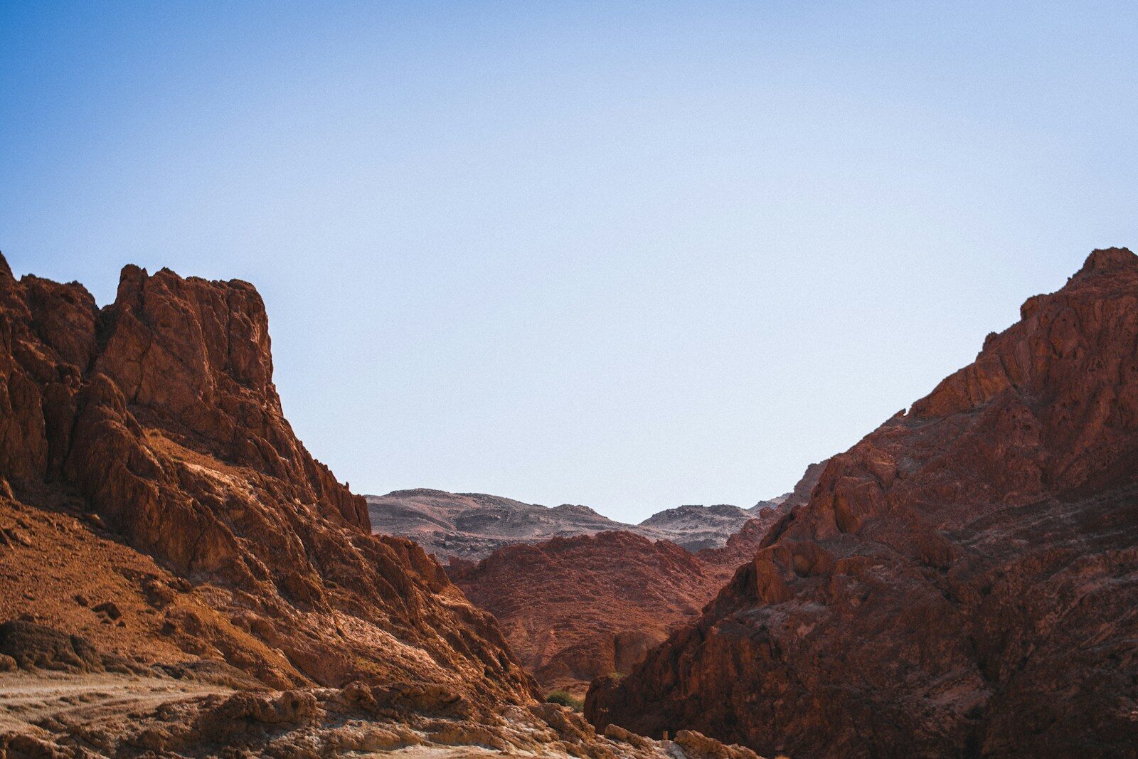 a view of a mountain range from the bottom of a canyon