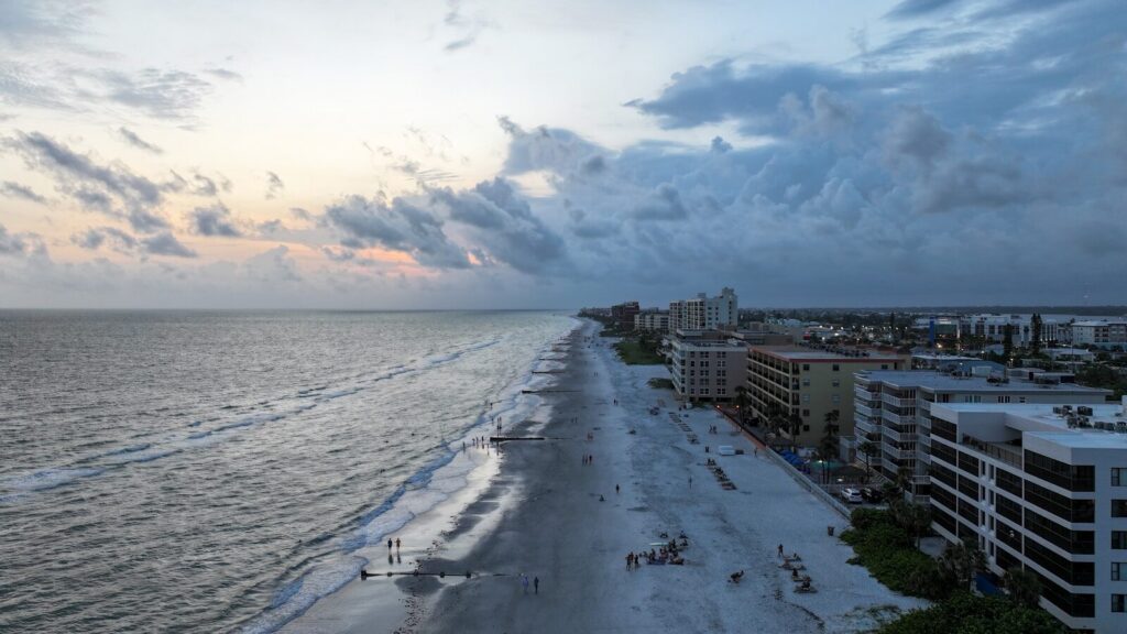 an aerial view of a beach and a city