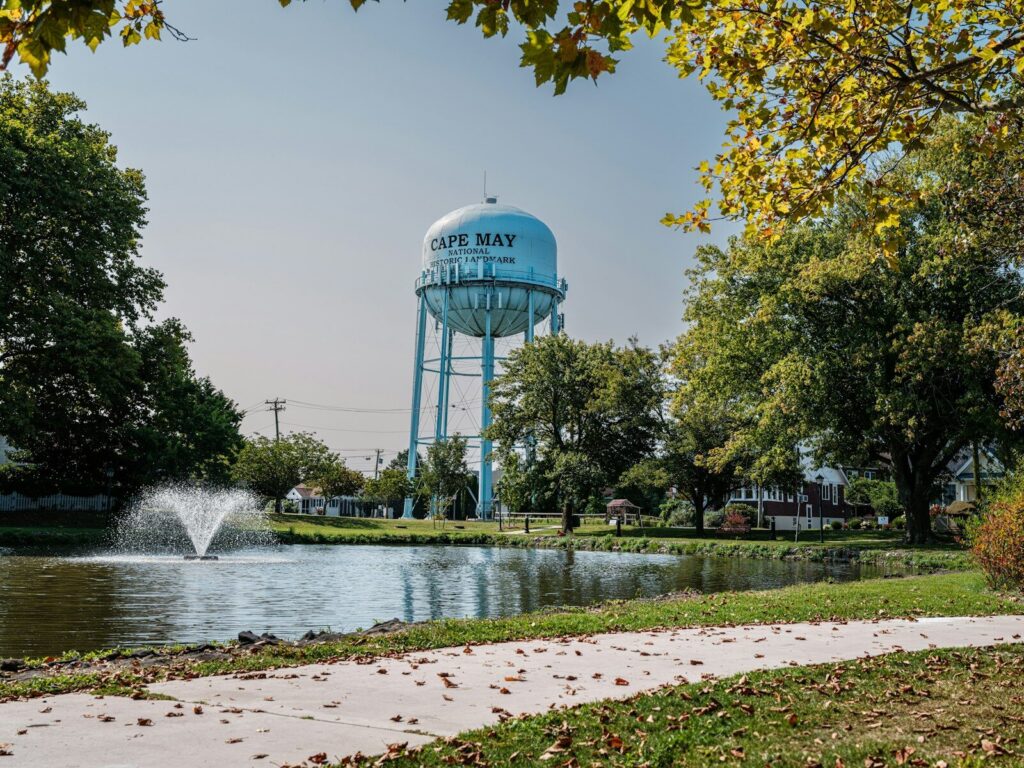 A water tower in the distance with a fountain in the foreground