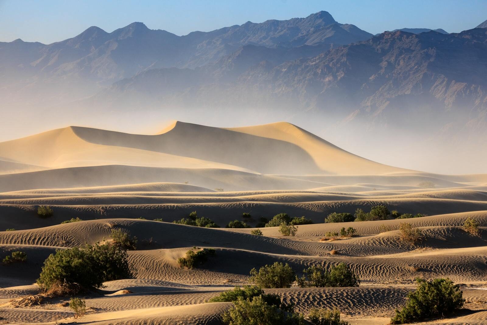 Breathtaking view of Mesquite Flat Sand Dunes in Death Valley National Park, California under clear blue skies.