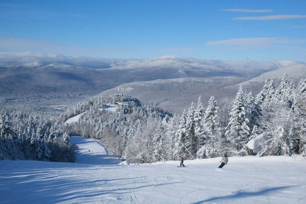 a group of people riding skis on top of a snow covered slope