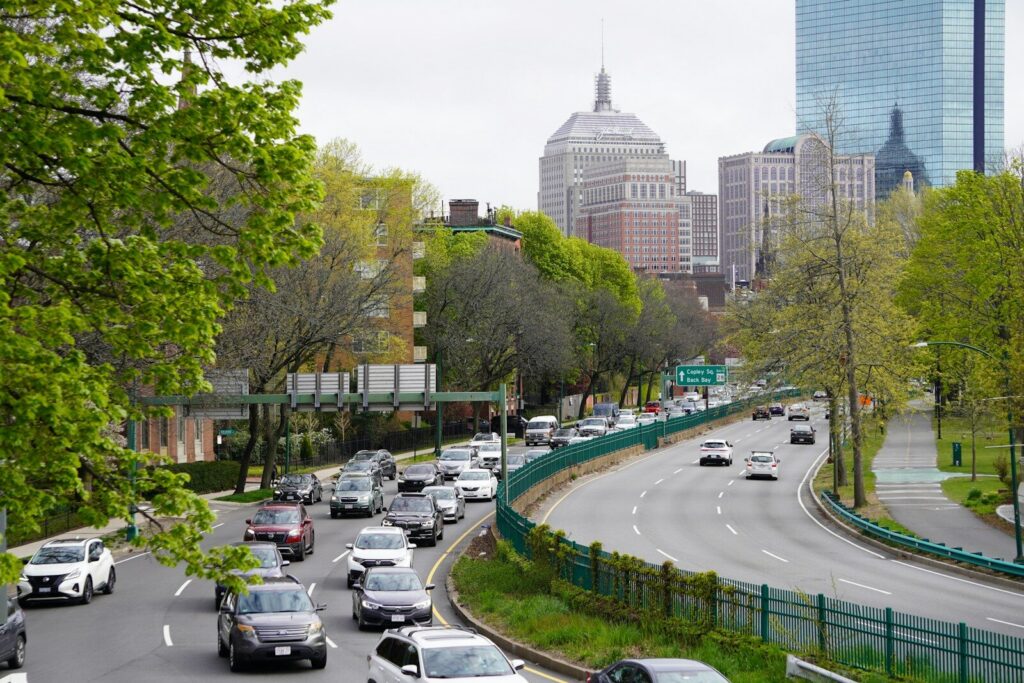 A street filled with lots of traffic next to tall buildings