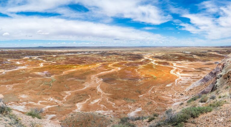 a scenic view of a barren landscape with a blue sky