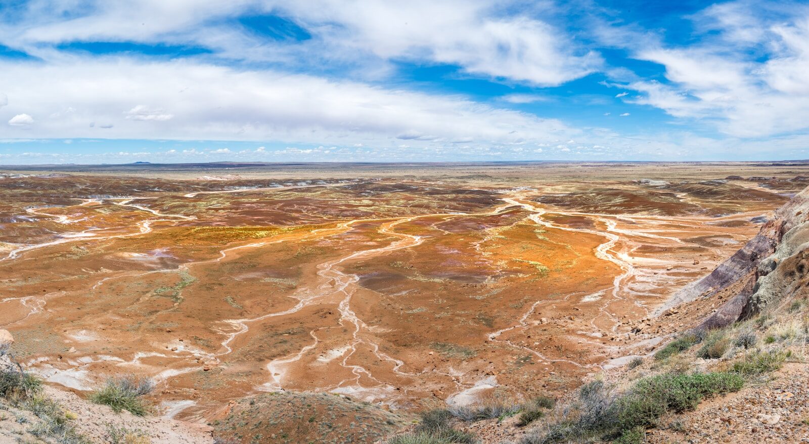 a scenic view of a barren landscape with a blue sky