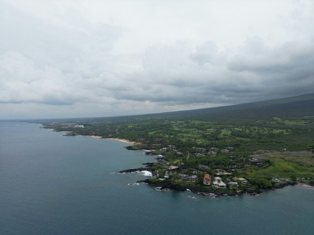 Aerial view of a coastal town under a cloudy sky.