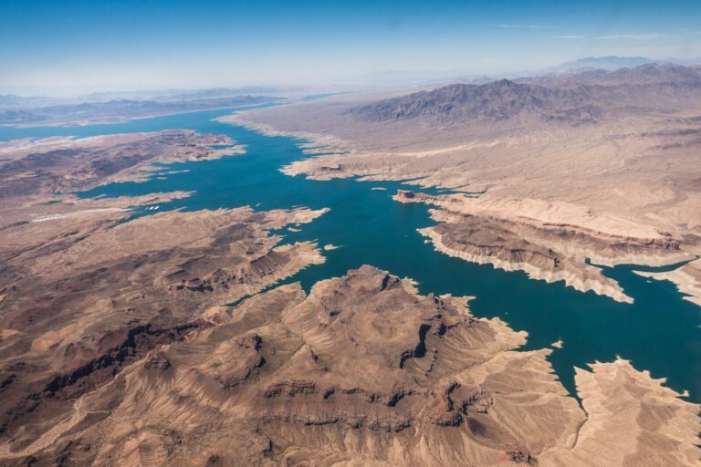 aerial photography of lake between desert