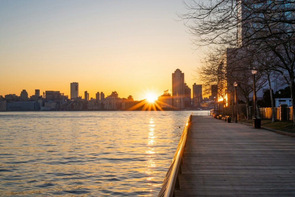 The sun is setting over the water in the city