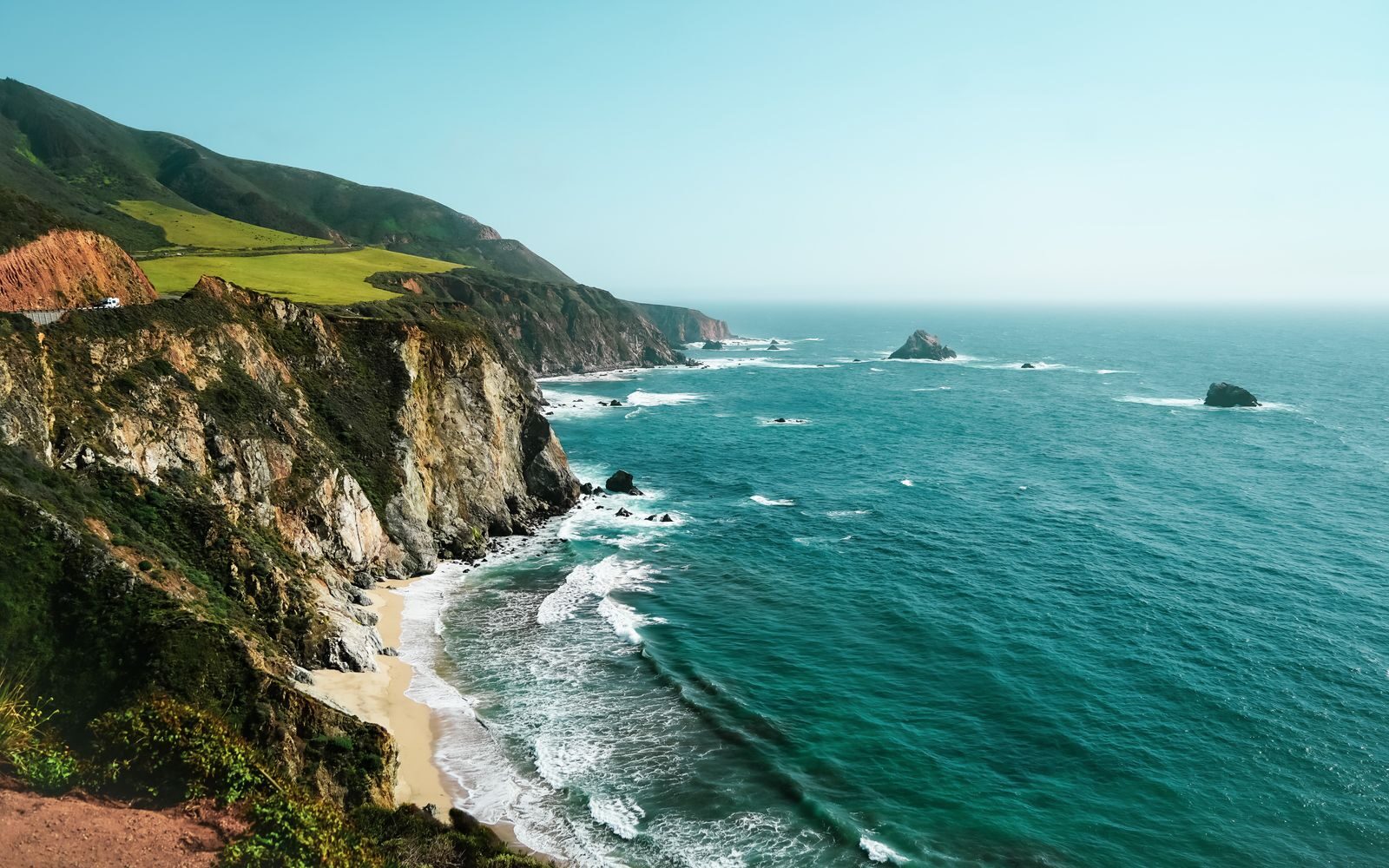 Breathtaking view of Big Sur's rugged coastline with cliffs and waves in California, USA.
