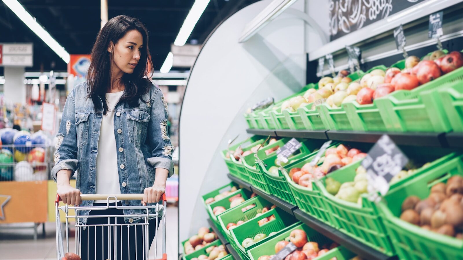 Woman shops for produce at a supermarket