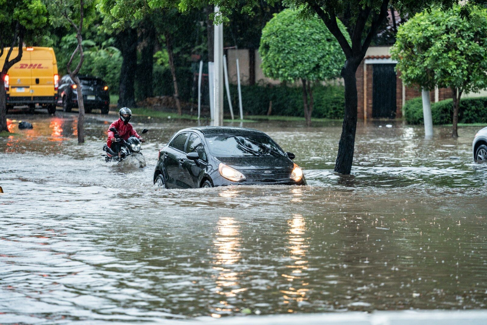 Cars driving through a flooded street during a storm