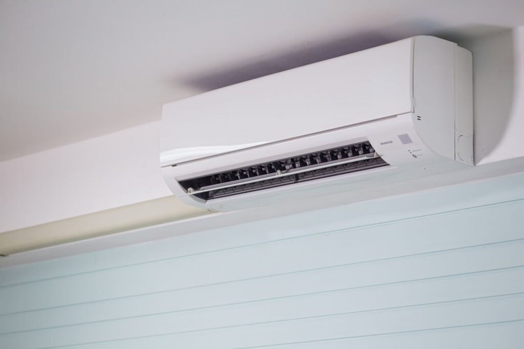 Close-up of a wall-mounted air conditioner indoors, showcasing sleek design for modern cooling solutions.