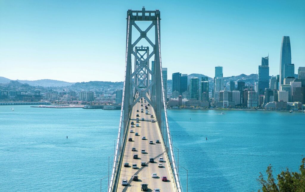 gray metal bridge over blue sea during daytime