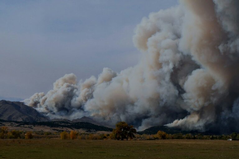 white smoke coming out from brown field