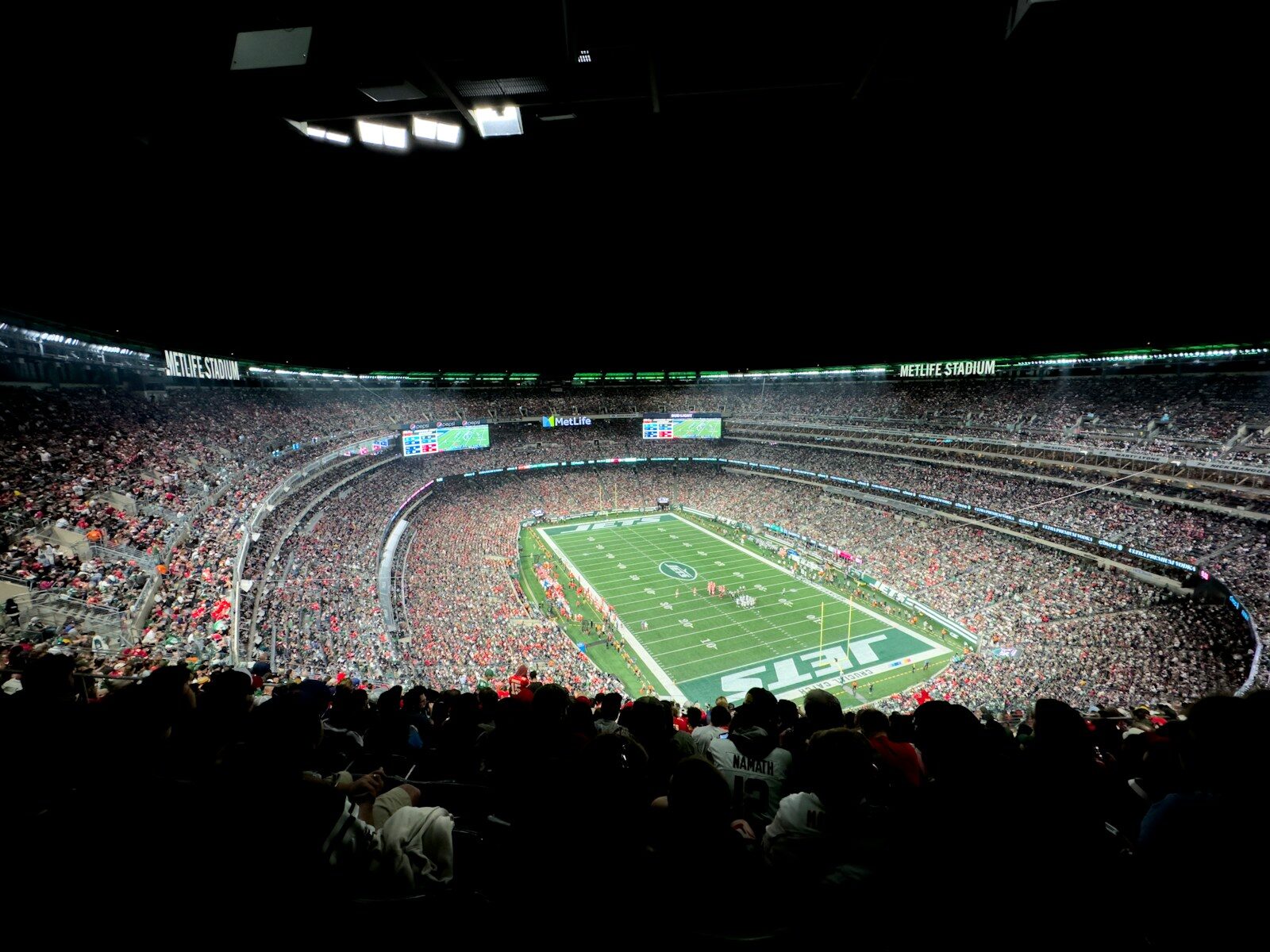 a stadium filled with lots of people watching a football game